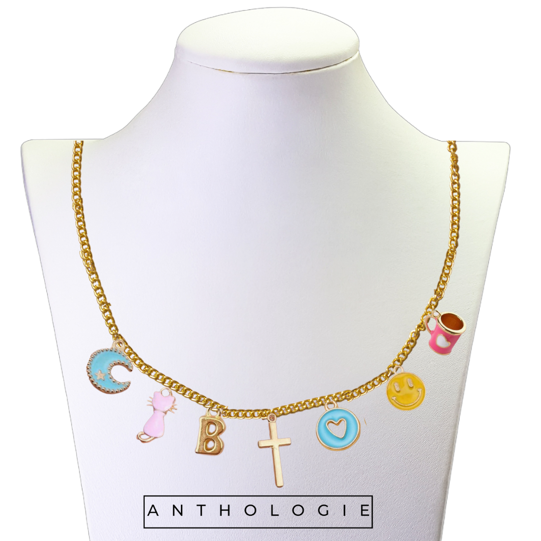 Necklace with various charms on a mannequin bust with 'Anthologie' branding.