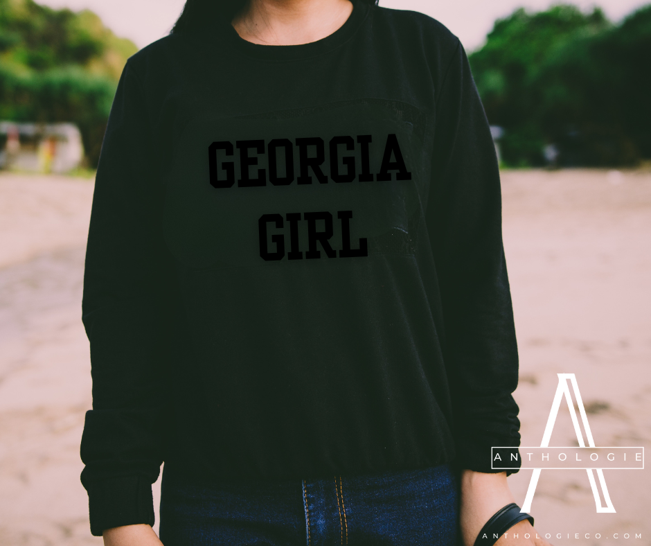 Woman wearing Georgia Girl state pride crewneck with jeans